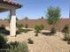 Lovely backyard featuring low-maintenance desert landscaping with decorative gravel and greenery at 25109 N 173Rd Dr, Surprise, AZ 85387
