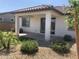 Charming backyard featuring a covered patio and neat landscaping with decorative rocks at 25109 N 173Rd Dr, Surprise, AZ 85387