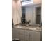 Bathroom featuring a double sink, granite countertop, framed mirror, and modern cabinetry with neutral paint at 25109 N 173Rd Dr, Surprise, AZ 85387