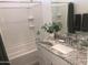 Bathroom featuring vanity sink with granite countertop, modern fixtures, and tiled shower and tub at 25109 N 173Rd Dr, Surprise, AZ 85387