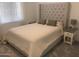 Bedroom featuring a large window, a well-made bed with a headboard, two pillows, and two nightstands at 25109 N 173Rd Dr, Surprise, AZ 85387