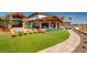 Clubhouse exterior featuring outdoor seating and manicured lawns, perfect for community gatherings and relaxation at 25109 N 173Rd Dr, Surprise, AZ 85387