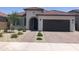Charming single-story home with desert landscaping, paver driveway and dark garage door at 25109 N 173Rd Dr, Surprise, AZ 85387