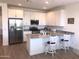 Modern kitchen with stainless steel appliances, granite counters, and island seating at 25109 N 173Rd Dr, Surprise, AZ 85387