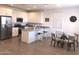 Modern kitchen with white cabinets, granite countertops, stainless steel appliances, and dining area at 25109 N 173Rd Dr, Surprise, AZ 85387