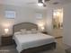 Bright main bedroom with large bed and ensuite bathroom featuring updated fixtures at 25109 N 173Rd Dr, Surprise, AZ 85387
