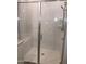 Elegant walk-in shower featuring glass door and walls, white subway tile, and a built-in shower bench at 25109 N 173Rd Dr, Surprise, AZ 85387