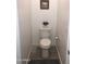 A cozy, minimalist toilet room featuring neutral walls, modern fixtures, and sleek, wood-look tile flooring at 25109 N 173Rd Dr, Surprise, AZ 85387