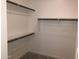 Bright walk-in closet with neutral walls, carpeted floor, and multiple levels of hanging and shelf storage at 25109 N 173Rd Dr, Surprise, AZ 85387