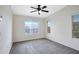 This bright bedroom features neutral walls, carpet, large windows, and a ceiling fan for comfort at 280 S Evergreen Rd # 1296, Tempe, AZ 85288