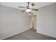 This carpeted bedroom is bright and spacious, with a ceiling fan for comfort and a door to another room at 280 S Evergreen Rd # 1296, Tempe, AZ 85288