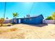 Exterior shot of the house showcasing its backyard, block fence, and landscaping at 3115 N 55Th Ave, Phoenix, AZ 85031
