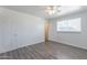 Bright bedroom with wood-look floors, a ceiling fan, and a window at 3115 N 55Th Ave, Phoenix, AZ 85031