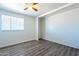 Bedroom featuring wood-look floors, natural light, and an open closet space at 3115 N 55Th Ave, Phoenix, AZ 85031