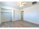 Bedroom with wood-look flooring, closet, and an entrance to another room at 3115 N 55Th Ave, Phoenix, AZ 85031