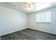 Bedroom featuring white-painted brick walls, wood-look floors, and natural light at 3115 N 55Th Ave, Phoenix, AZ 85031
