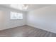 Bedroom featuring gray laminate wood flooring, neutral walls, and window at 3115 N 55Th Ave, Phoenix, AZ 85031