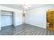 Bedroom featuring wood-look floors and an open closet with access to the bathroom at 3115 N 55Th Ave, Phoenix, AZ 85031