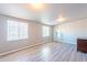 Bonus room with gray walls, wood-look floors, and natural light from two windows at 3115 N 55Th Ave, Phoenix, AZ 85031