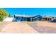 Charming blue single-story home featuring a well-manicured front yard and a concrete driveway at 3115 N 55Th Ave, Phoenix, AZ 85031