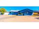 Charming single-story blue home with a tidy front yard and desert landscaping under a bright blue sky at 3115 N 55Th Ave, Phoenix, AZ 85031