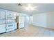 Bright kitchen with white appliances, white cabinets, and tile flooring at 3115 N 55Th Ave, Phoenix, AZ 85031