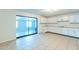 Bright kitchen with white cabinets, tile flooring, and access to other room at 3115 N 55Th Ave, Phoenix, AZ 85031