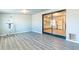 Spacious living area features gray wood-look floors and sliding glass doors to the kitchen at 3115 N 55Th Ave, Phoenix, AZ 85031