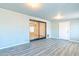 Large living area boasts gray wood-look floors and a glass sliding door for ample light at 3115 N 55Th Ave, Phoenix, AZ 85031