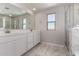 Bright bathroom featuring double sink vanity with white cabinets, and a glass-enclosed shower at 31822 N Bandit Rd, San Tan Valley, AZ 85143
