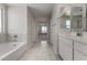 Bright bathroom with a soaking tub, dual vanity sinks and a clear view into the next room at 31822 N Bandit Rd, San Tan Valley, AZ 85143
