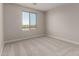 Bright bedroom featuring neutral walls, plush carpeting, and a window with neighborhood views at 31822 N Bandit Rd, San Tan Valley, AZ 85143