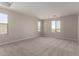 Spacious bedroom with neutral carpet and multiple windows offering natural light and desert views at 31822 N Bandit Rd, San Tan Valley, AZ 85143