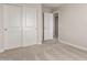 Cozy bedroom showcasing neutral walls, plush carpeting, and a closet with sliding doors at 31822 N Bandit Rd, San Tan Valley, AZ 85143