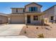 Inviting two-story home showcasing desert landscaping and a spacious two car garage at 31822 N Bandit Rd, San Tan Valley, AZ 85143