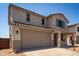 Inviting two-story home featuring a spacious two car garage and desert landscaping at 31822 N Bandit Rd, San Tan Valley, AZ 85143