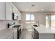 Bright kitchen featuring modern appliances, an island with a sink, and white cabinetry at 31822 N Bandit Rd, San Tan Valley, AZ 85143