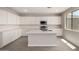 Modern kitchen featuring white cabinets, quartz countertops, and stainless steel appliances at 31822 N Bandit Rd, San Tan Valley, AZ 85143