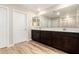 Elegant bathroom with double sink vanity, wood-like tile flooring, large mirror, and ample space at 31850 N Bandit Rd, San Tan Valley, AZ 85143