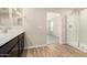 Modern bathroom with wood tile flooring, glass shower, stylish vanity, and excellent interior home design at 31850 N Bandit Rd, San Tan Valley, AZ 85143