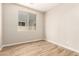 Bedroom with a large window providing natural light and wood-look tile flooring at 31850 N Bandit Rd, San Tan Valley, AZ 85143