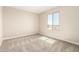 A well-lit bedroom with neutral walls and carpeting, featuring a large window for ample natural light at 31850 N Bandit Rd, San Tan Valley, AZ 85143