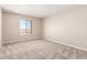 Bedroom with neutral carpeting, blank walls and a window for plenty of natural light at 31850 N Bandit Rd, San Tan Valley, AZ 85143