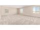 Bright bonus room featuring neutral walls, carpet flooring, and multiple windows with ample natural light at 31850 N Bandit Rd, San Tan Valley, AZ 85143