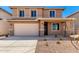 Two-story home with a front yard featuring desert landscaping, attached garage, and neutral color palette at 31850 N Bandit Rd, San Tan Valley, AZ 85143