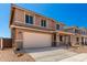 Home exterior featuring desert landscaping, two-car garage, neutral color palette, and concrete driveway at 31850 N Bandit Rd, San Tan Valley, AZ 85143