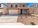 Home exterior featuring desert landscaping, two-car garage, neutral color palette, and a well-maintained front yard at 31850 N Bandit Rd, San Tan Valley, AZ 85143