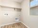 Bright laundry room featuring tile flooring and a window offering a functional and inviting space at 31850 N Bandit Rd, San Tan Valley, AZ 85143