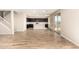 Open-concept living area showcasing wood-look tile floors, a staircase, and access to the kitchen at 31850 N Bandit Rd, San Tan Valley, AZ 85143