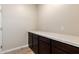 Storage area with white quartz countertop and dark cabinets; perfect for a functional space at 31850 N Bandit Rd, San Tan Valley, AZ 85143